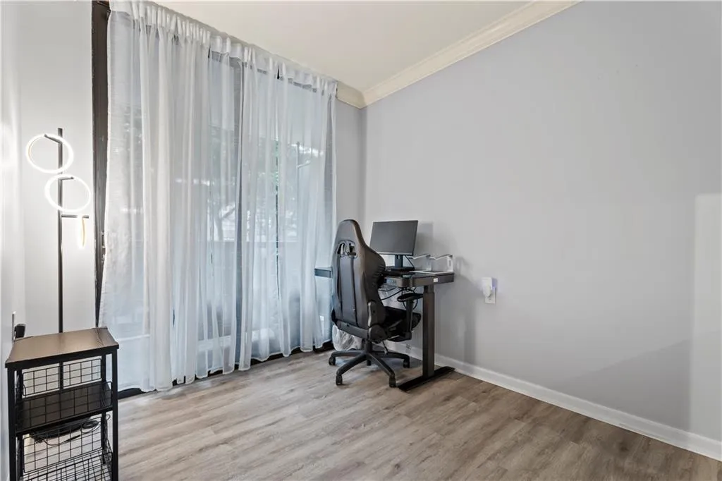 Home office featuring crown molding and wood finished floors