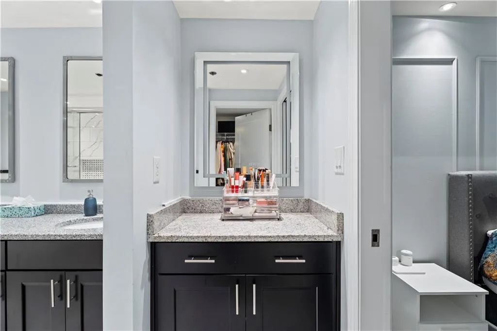 Bathroom with vanity, recessed lighting, and a spacious closet