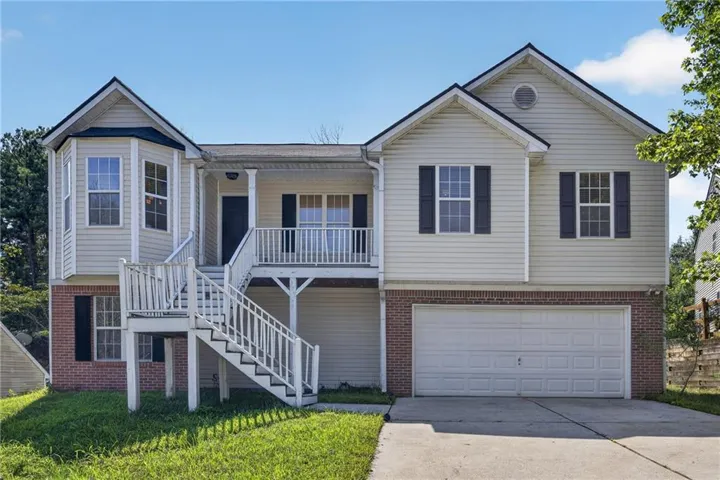 Two-story exterior with vinyl siding and brick accents