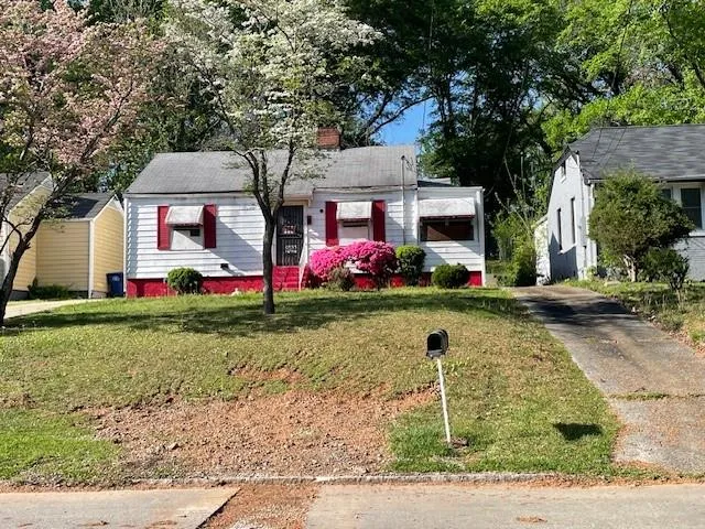 View of front of home featuring a front lawn and a chimney