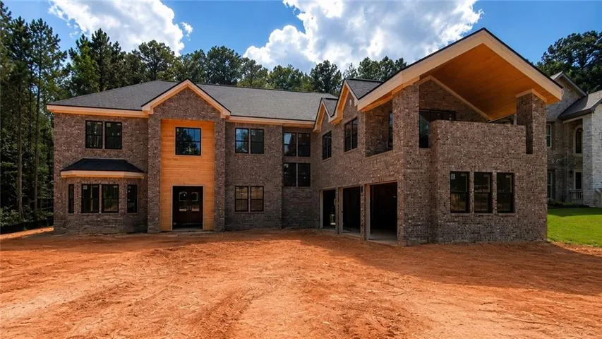 Brick exterior with wood-clad accents and black-framed windows