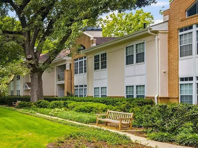 Brick and stucco exterior with multiple windows