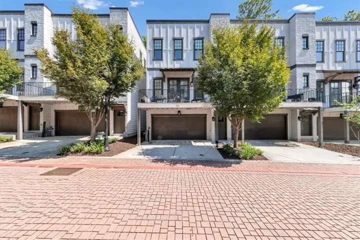 Modern townhome exterior with white brick and horizontal siding