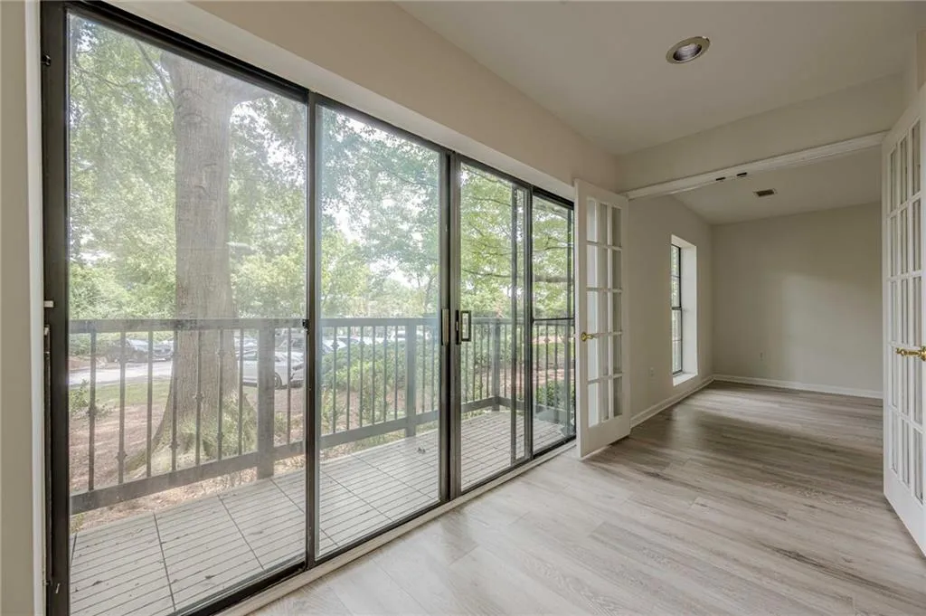 Doorway to outside with french doors and wood finished floors