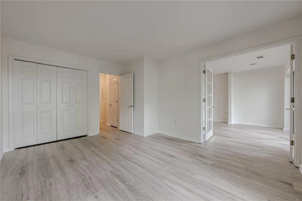 Unfurnished bedroom with light wood finished floors and a closet