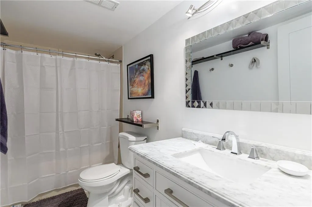 Full bathroom featuring vanity and tub.