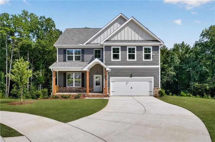 Two-story home with a gabled roof and gray siding
