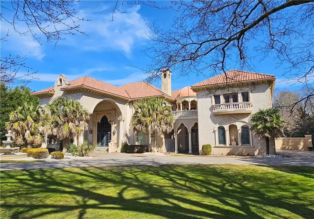 Mediterranean / spanish-style house with a front yard and a balcony