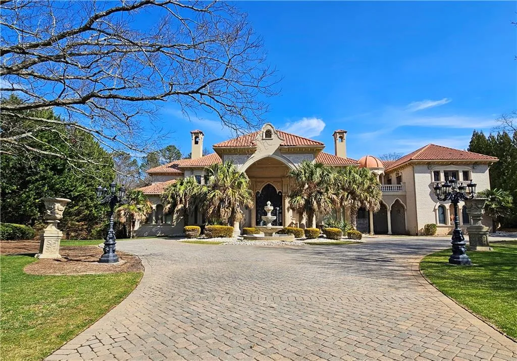 Mediterranean / spanish-style home featuring a front yard and a balcony
