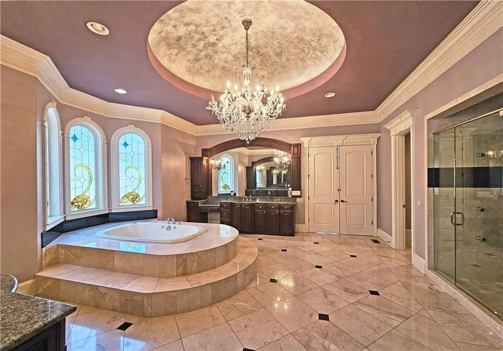 Bathroom featuring tile floors, vanity, a notable chandelier, and a raised ceiling