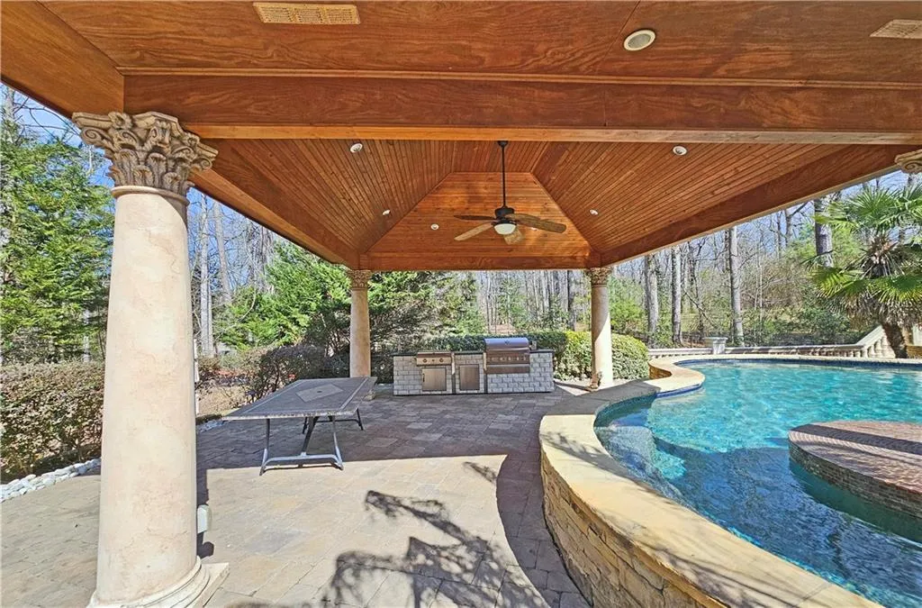 View of swimming pool featuring a patio area, grilling area, area for grilling, ceiling fan, and a gazebo