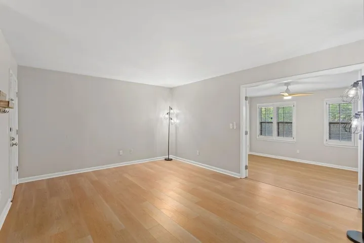 Light wood-finish flooring throughout, neutral wall paint, and a white ceiling