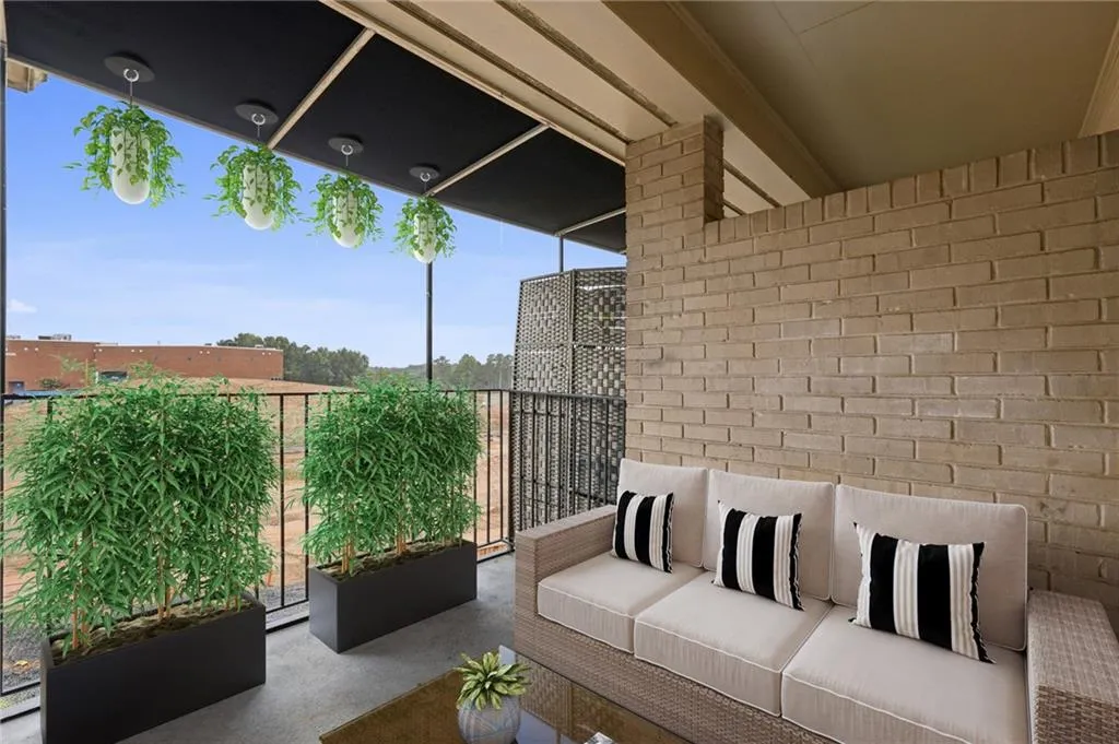 Digitally staged. Balcony with an outdoor living space