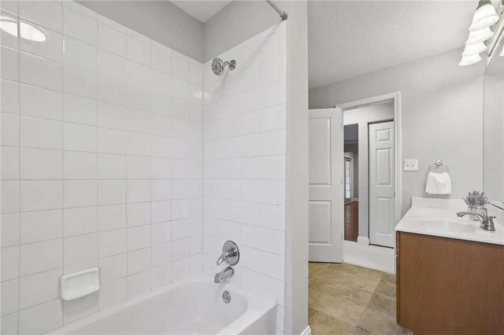 Bathroom with vanity, bathtub / shower combination