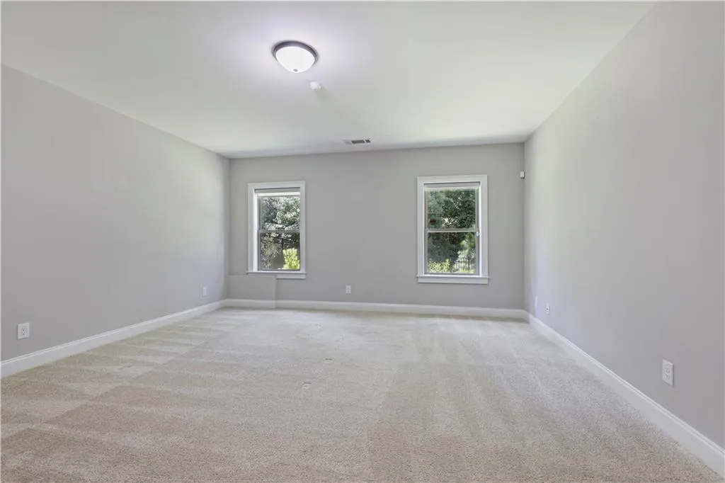 Carpeted empty room featuring plenty of natural light