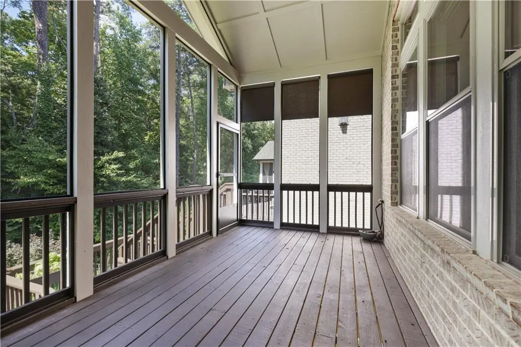 Unfurnished sunroom featuring vaulted ceiling and a healthy amount of sunlight