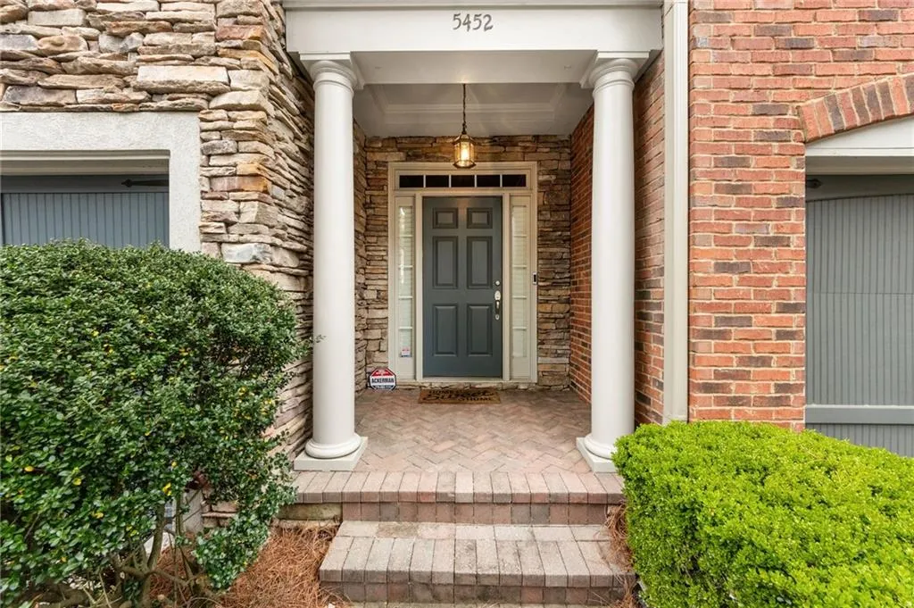 Entrance to property featuring brick siding