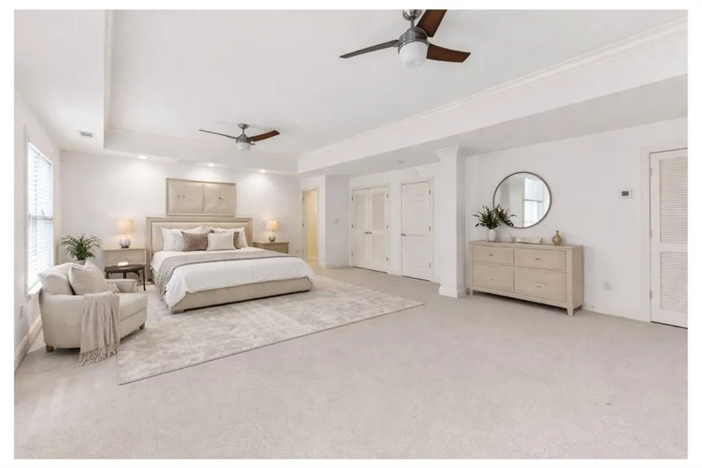 Virtually Staged - Terrace Level Bedroom featuring a tray ceiling, light carpet, and ceiling fan (piano wall)