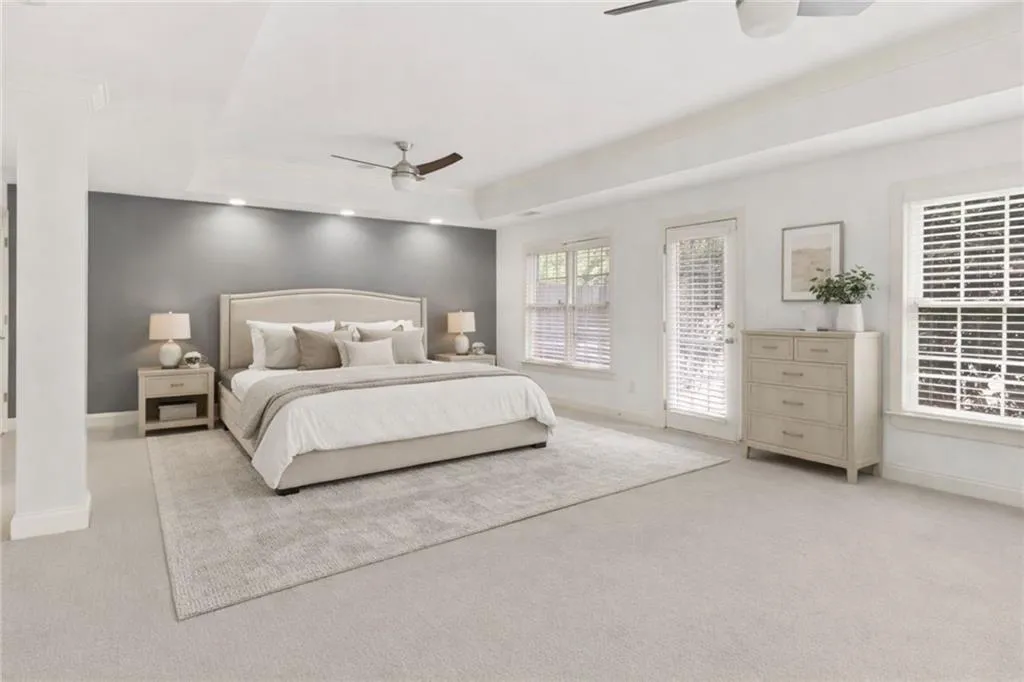 Virtually Staged Terrace Level Bedroom suite with raised ceiling, ceiling fan, and recessed lighting (sofa wall)