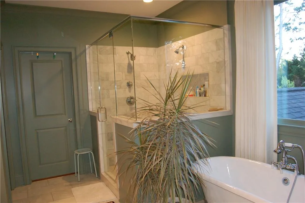 Ahh, the sumptuous & spa inspired marble clad bathroom with a frameless, glass walk in shower with dual shower heads.  Soaking tub.