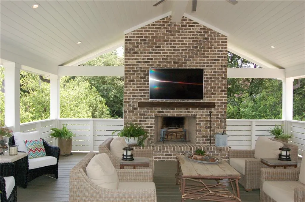 WOW!  An entertainer's dream!  23 x 23 covered porch anchored by a wood burning fireplace.