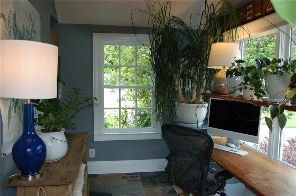 3 walls of windows in office/sun room, slate floor and vaulted ceiling.
