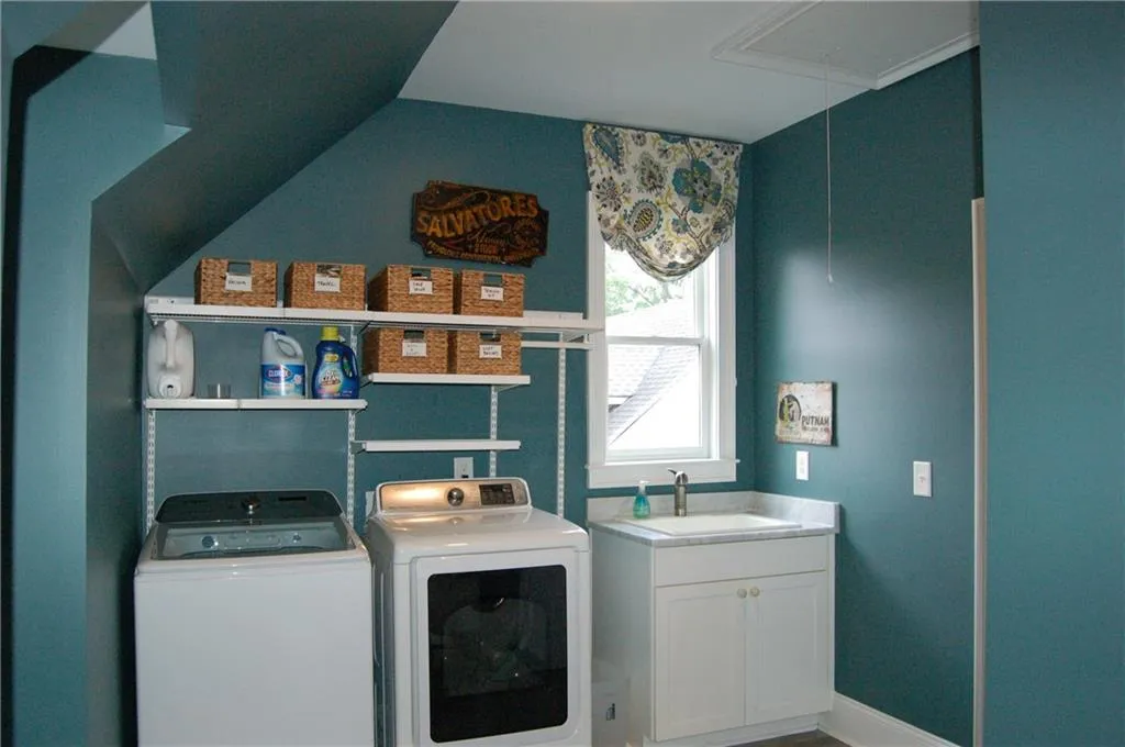 An organized laundry room complete with a hidden, full size closet for all those extra's.  Washer & Dryer convey.