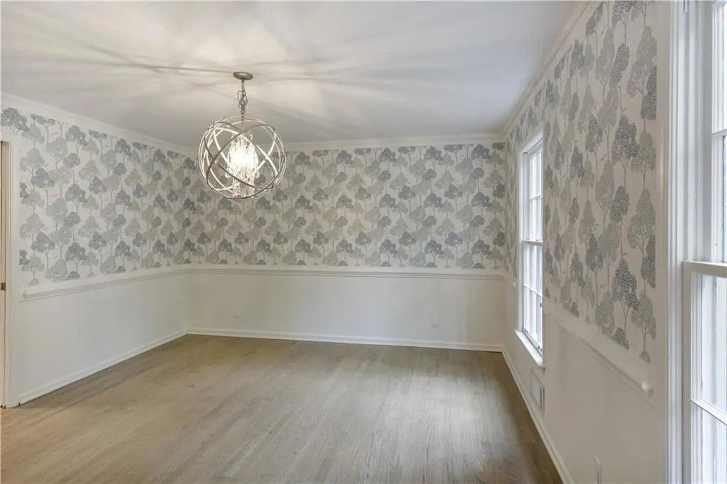 Spacious dining room with stylish wallpaper