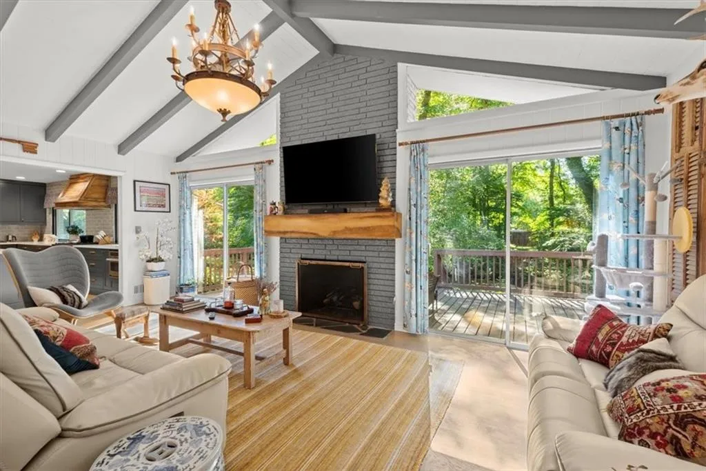 Family Room in open and has a lot of natural light with glass doors and windows and view of the wooded back yard