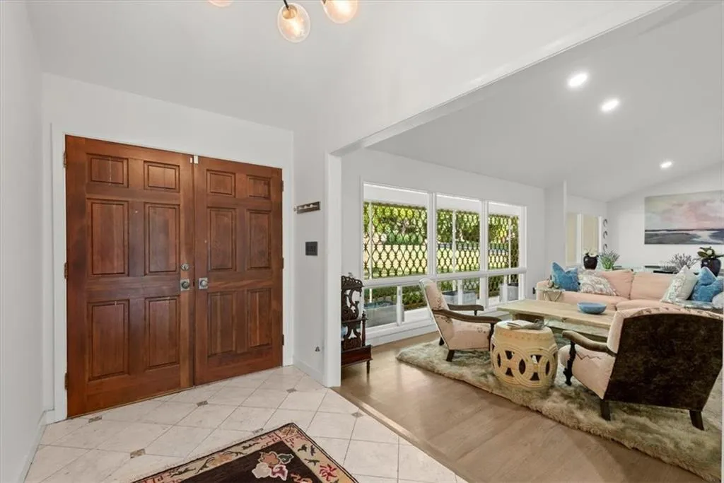 Foyer featuring lofted ceiling and hardwood floors