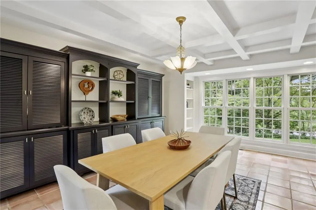 Just WOW! Beamed and coffered ceiling, wall of windows, built-ins! A showcase space where natural light enhances craftsman design. Dine in the ambience of nature.