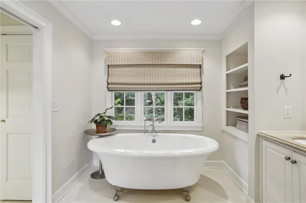 An elegant soaking tub bathed in natural light-your own private spa retreat.