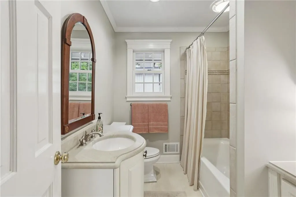 Guest bathroom with plenty of natural light. Notice additional vanity space tucked away in a well utilized, functional use of space.