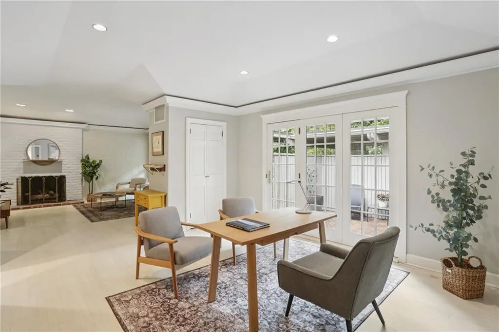 The office/dining/flex space continues with white hardwood flooring continues throughout.