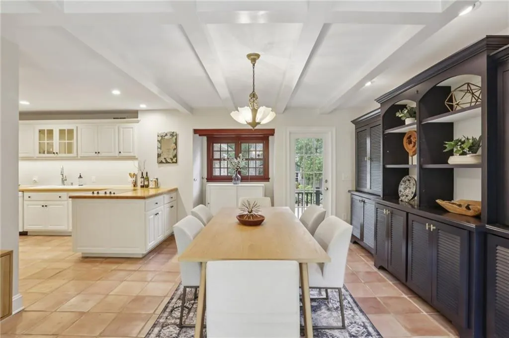 White and bright! The lighting, the open space, the windows, the cabinets, the ceiling-hand in hand working together to create a beautiful and enjoyable space.