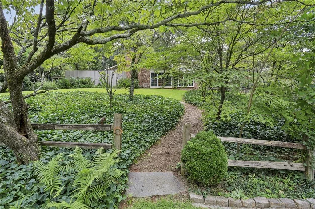 A nature path leads you to the front of the home front the street. What a pleasant space to take a walk and view nature.