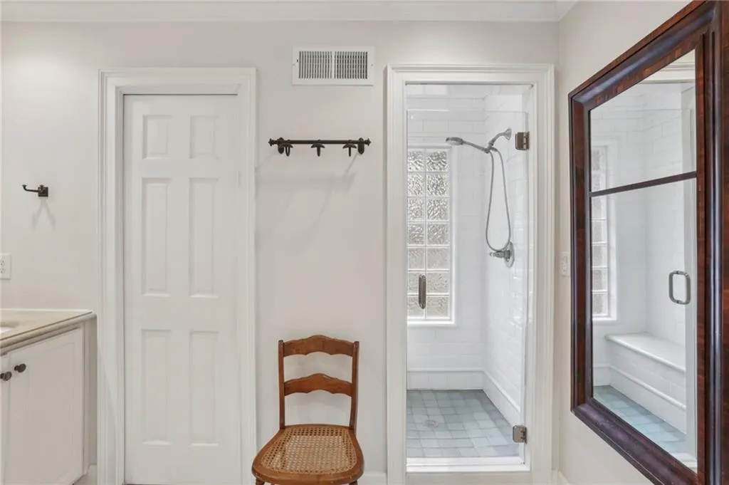 Well lit shower bathed in natural light! Notice the reflection of the shower bench. A relaxing space to take in nature.