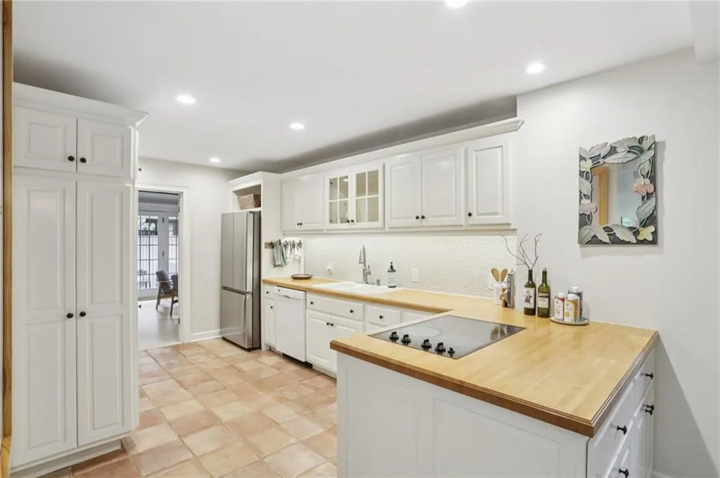 Cabinets and countertops in abundance. Conversation can easily flow from surrounding dining spaces.