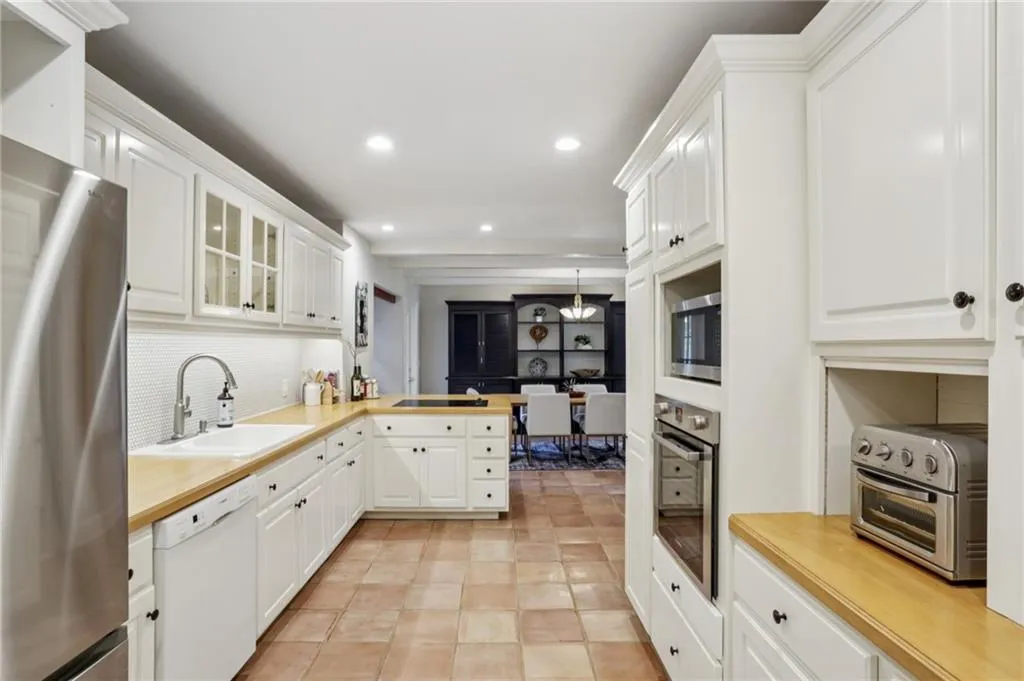 Centrally located, the kitchen is bright and functional. Recessed lighting continues throughout enhancing the well lit space. Plenty of space to cook and entertain family and guests.