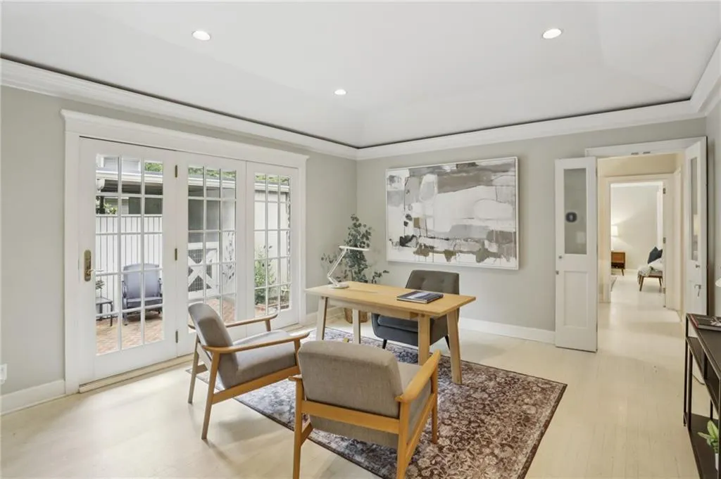 Natural light and view of the courtyard fills this delightful multi-use space. Office, sitting room,  dining area-You decide.  Doors gracefully in place leading to the kitchen.