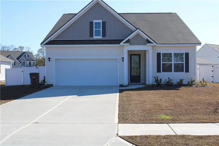 Siding exterior with dormer detail, attached garage, concrete driveway, and front entryway with transom window