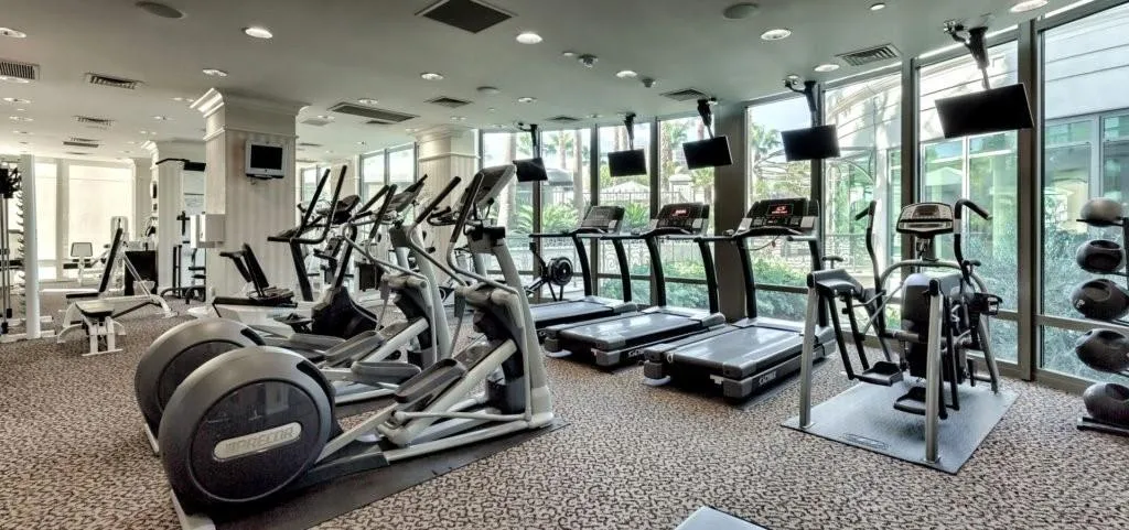 Exercise room featuring expansive windows and recessed lighting