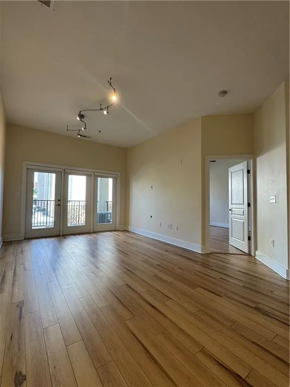Living room looking at bedroom door and patio