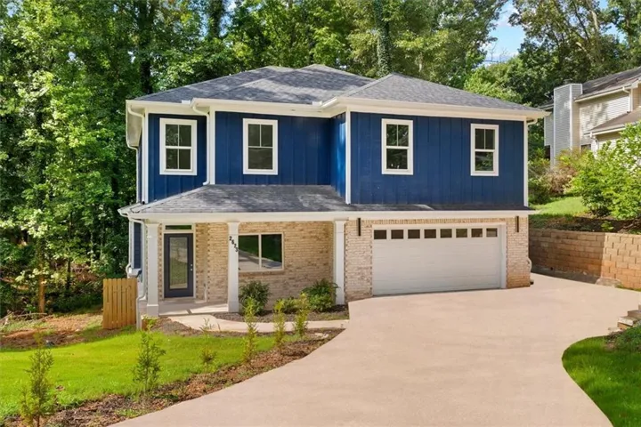 Two-story residence featuring a blue siding exterior with white trim windows and a light brick lower level