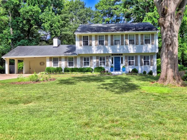 Just another view of this lovely home which shows the manicured lawn. There is also an extra parking pad to the left of the Carport.
