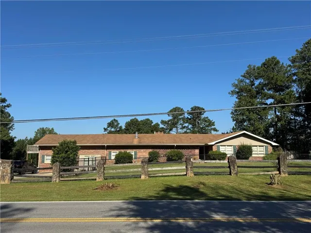 Brick exterior construction with a brown shingle roof