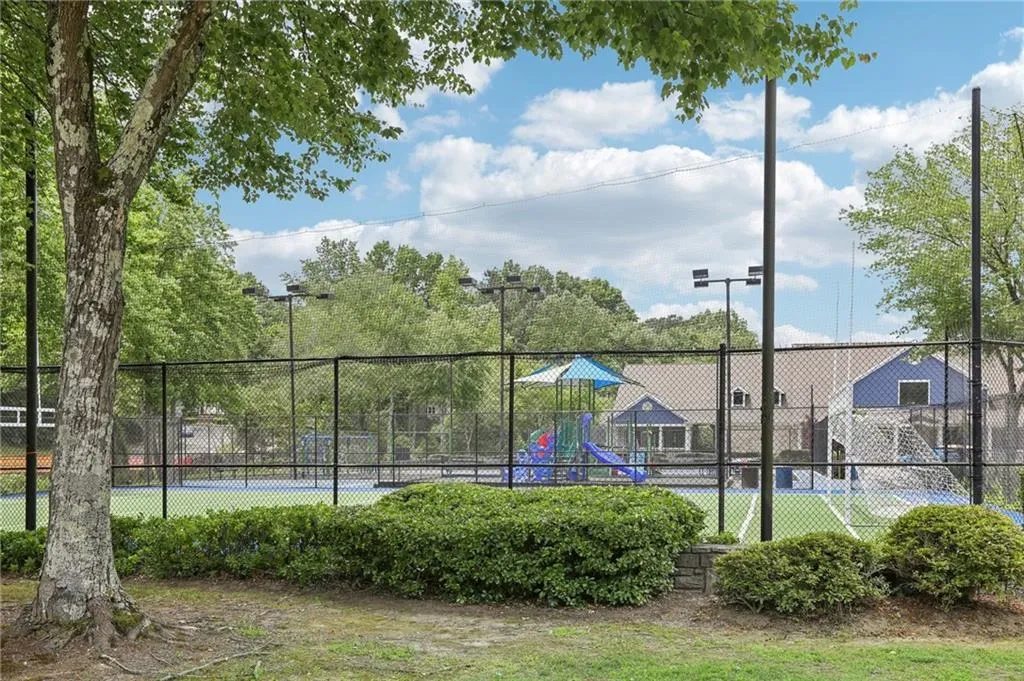 View of sport court with a playground