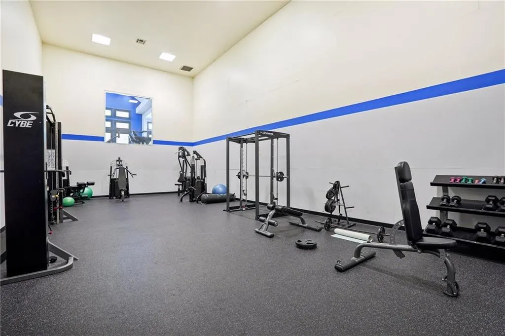 Exercise room featuring a high ceiling