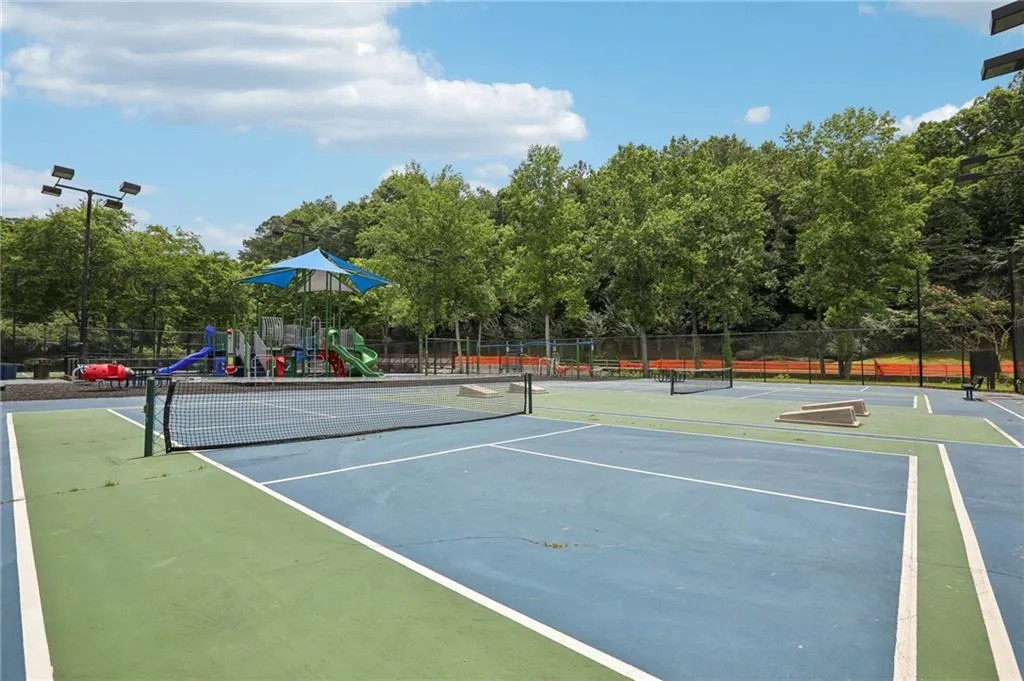 View of sport court featuring a playground