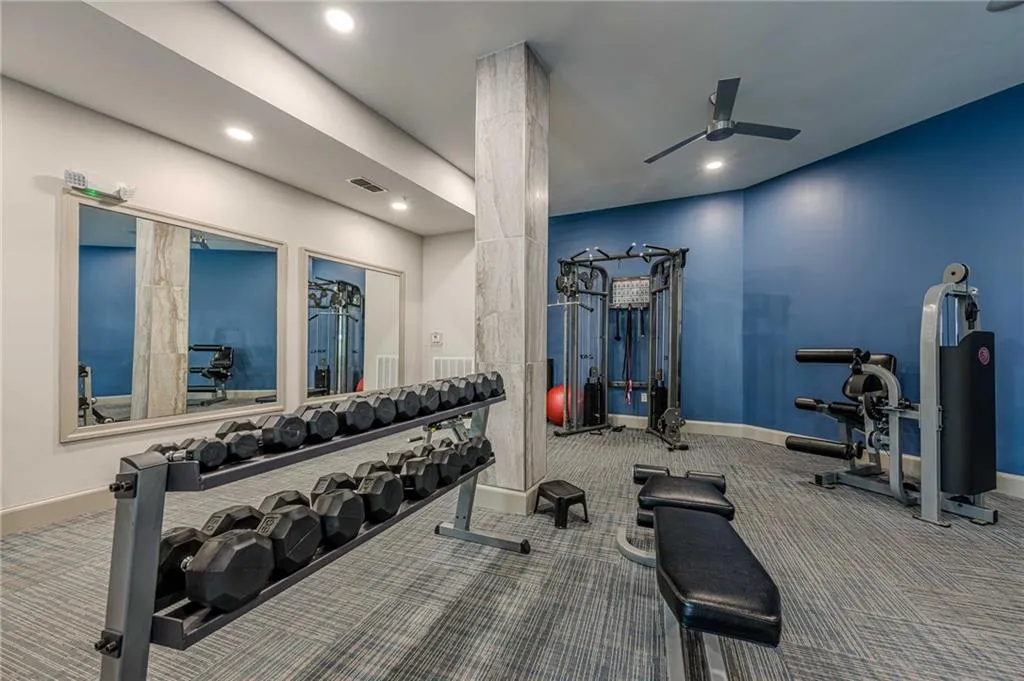 Workout area with recessed lighting and a ceiling fan